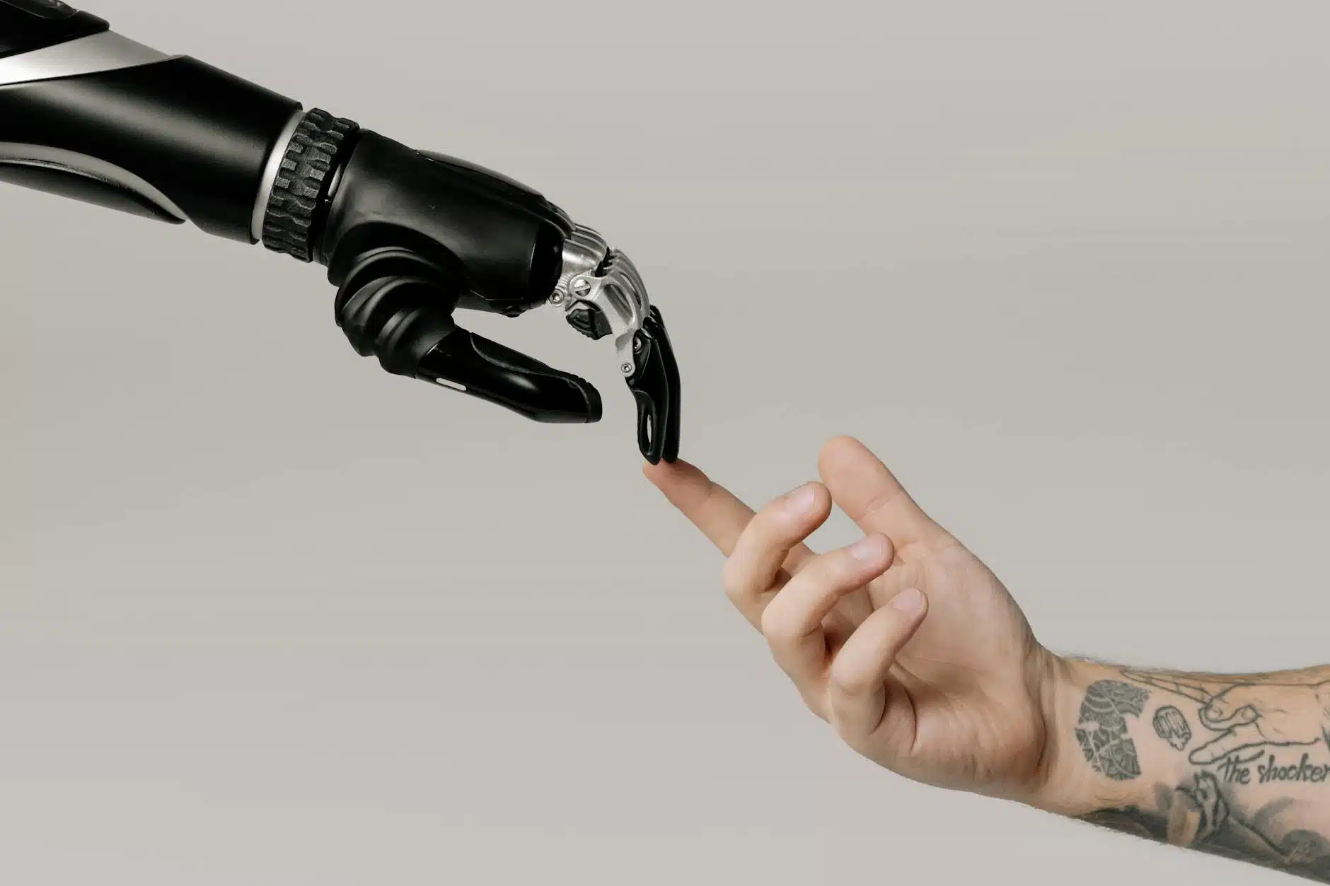 Bionic hand and human hand finger pointing demonstrating free GPT AI technology interaction